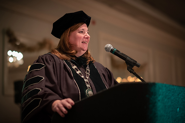 Dr. Therese A. Scanlan addressing graduates at Oak Point University's December 2022 commencement