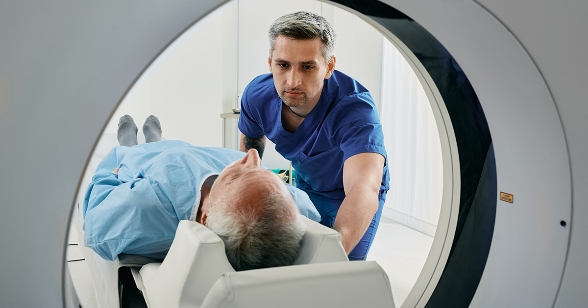 CT technologist prepping a man for a scan